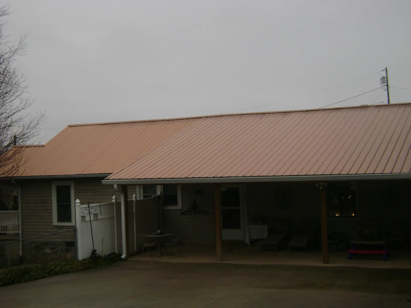 Copper toned metal roof over a wide covered patio in Winnemucca